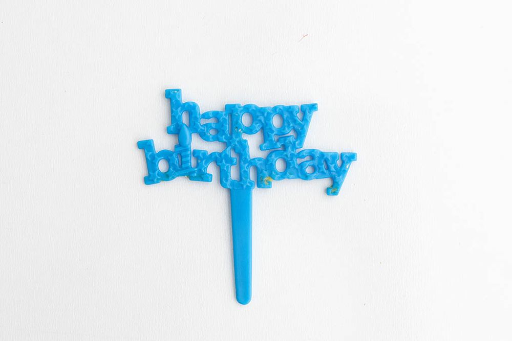Blue glitter happy birthday cake topper on stick for birthday party cake decoration.