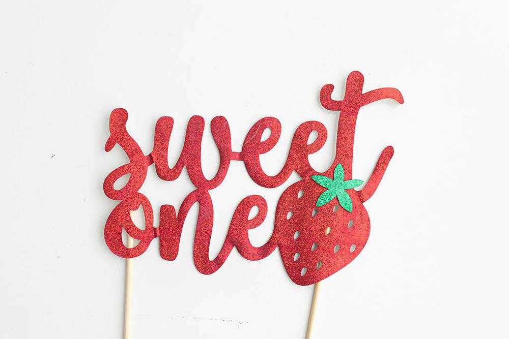 Red glitter sweet one cake topper with strawberry accent; for "Sweet One" birthday photoshoot in Canyon Lake.