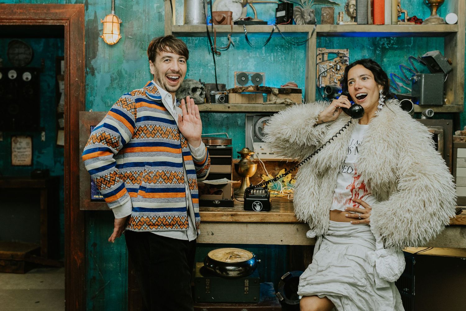 Studio workshop self portraits captured in vintage teal tones with white feathered prop and rustic crafting backdrop.