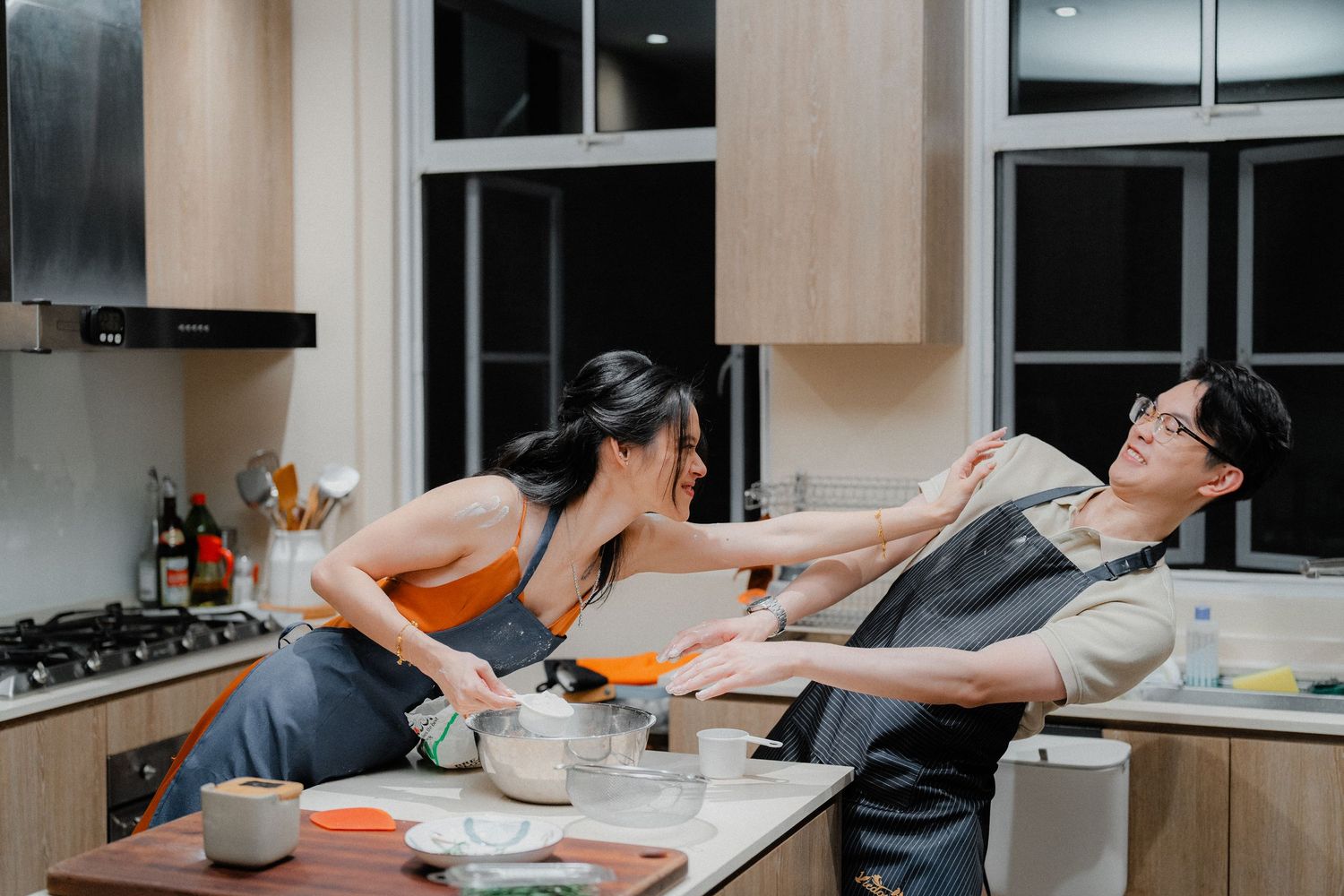Playful moment in the kitchen while cooking together.