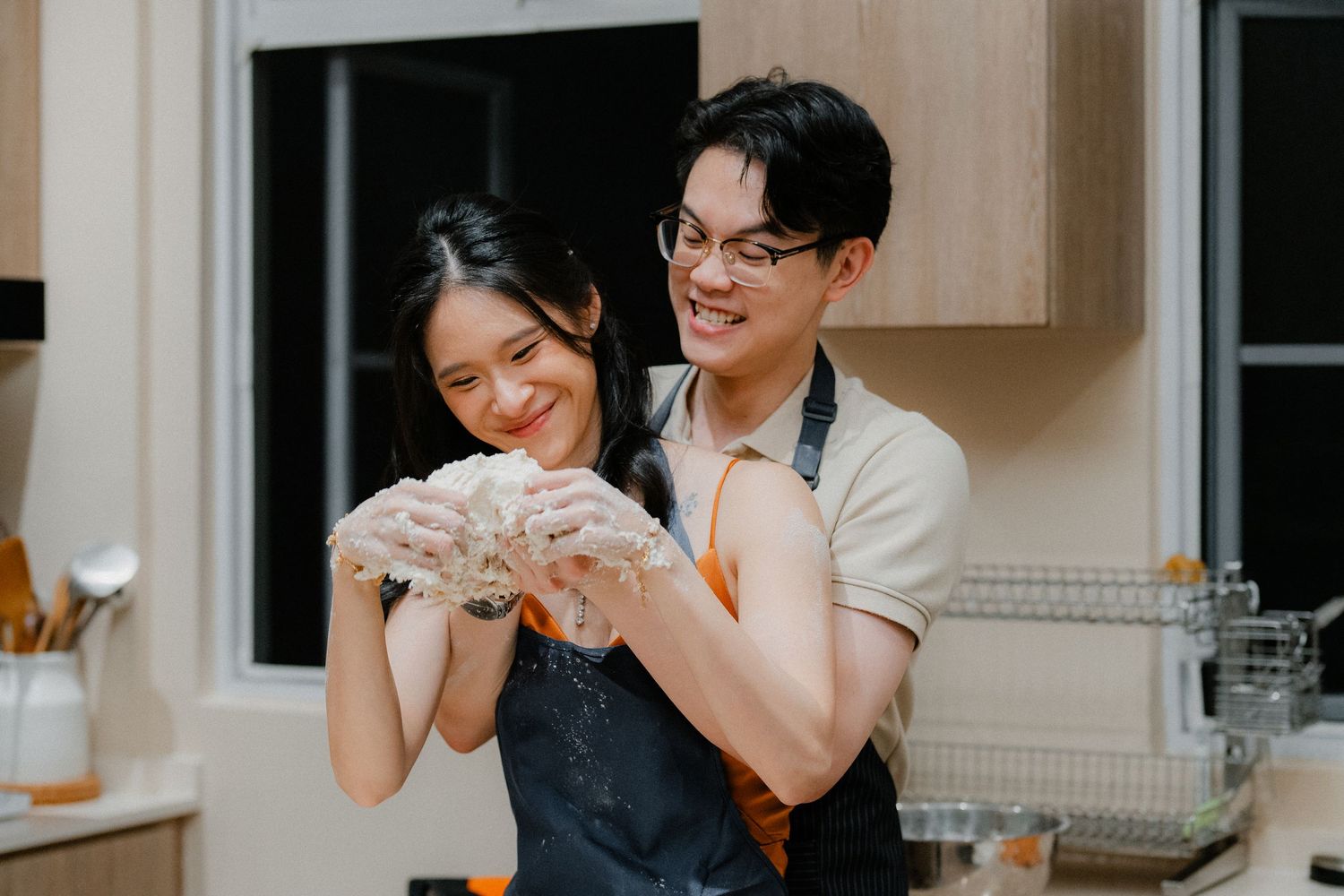 Joyful moment while baking together in a modern kitchen.