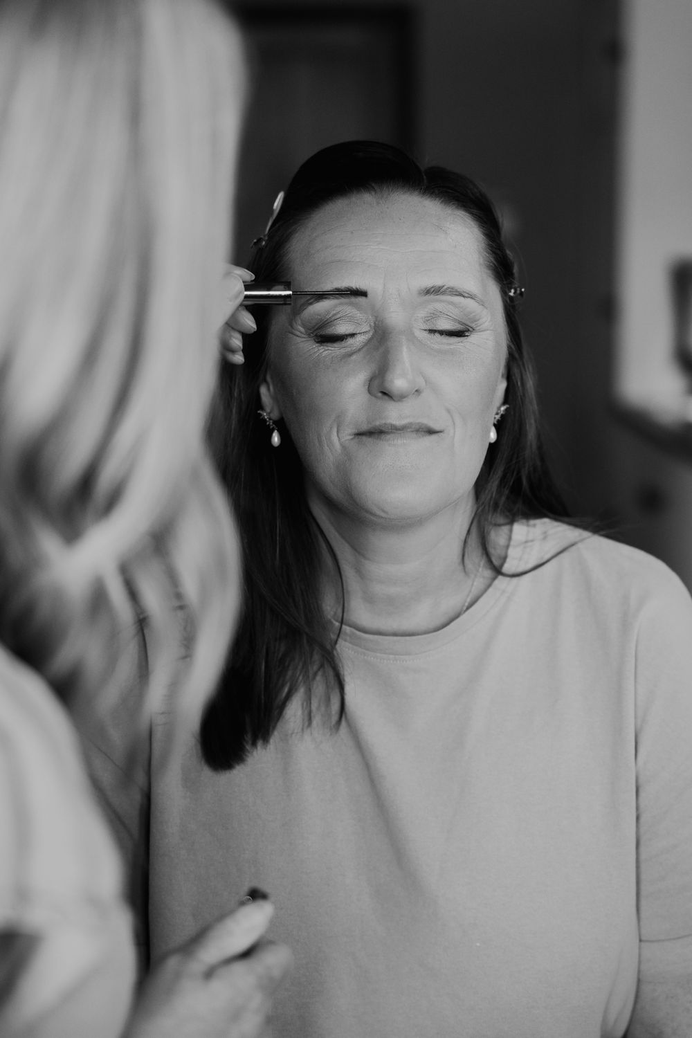 Black and white candid moments captured during wedding preparations.