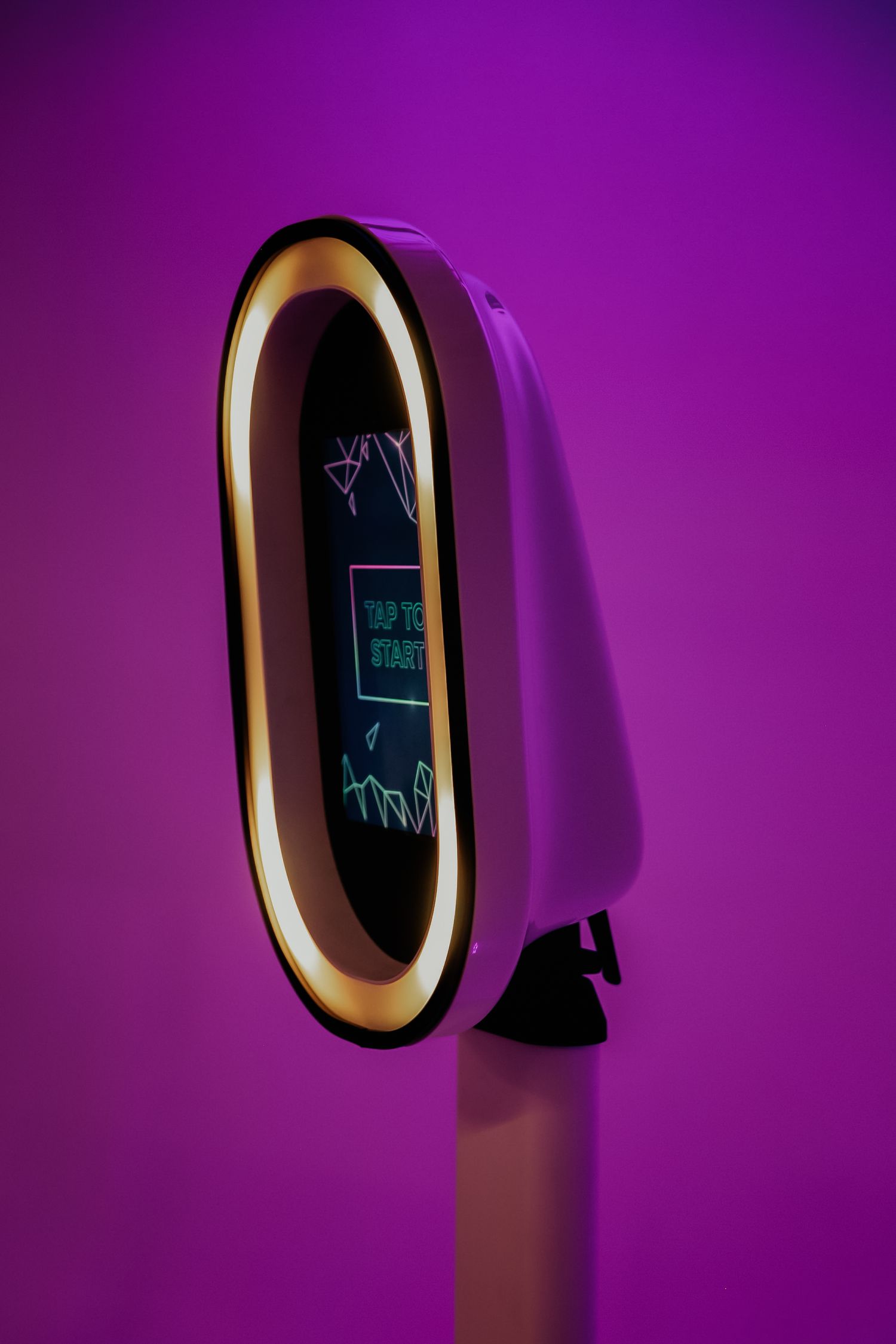 Artistic sequence of oval illuminated mirror or frame against purple wall casting dramatic angular shadows.