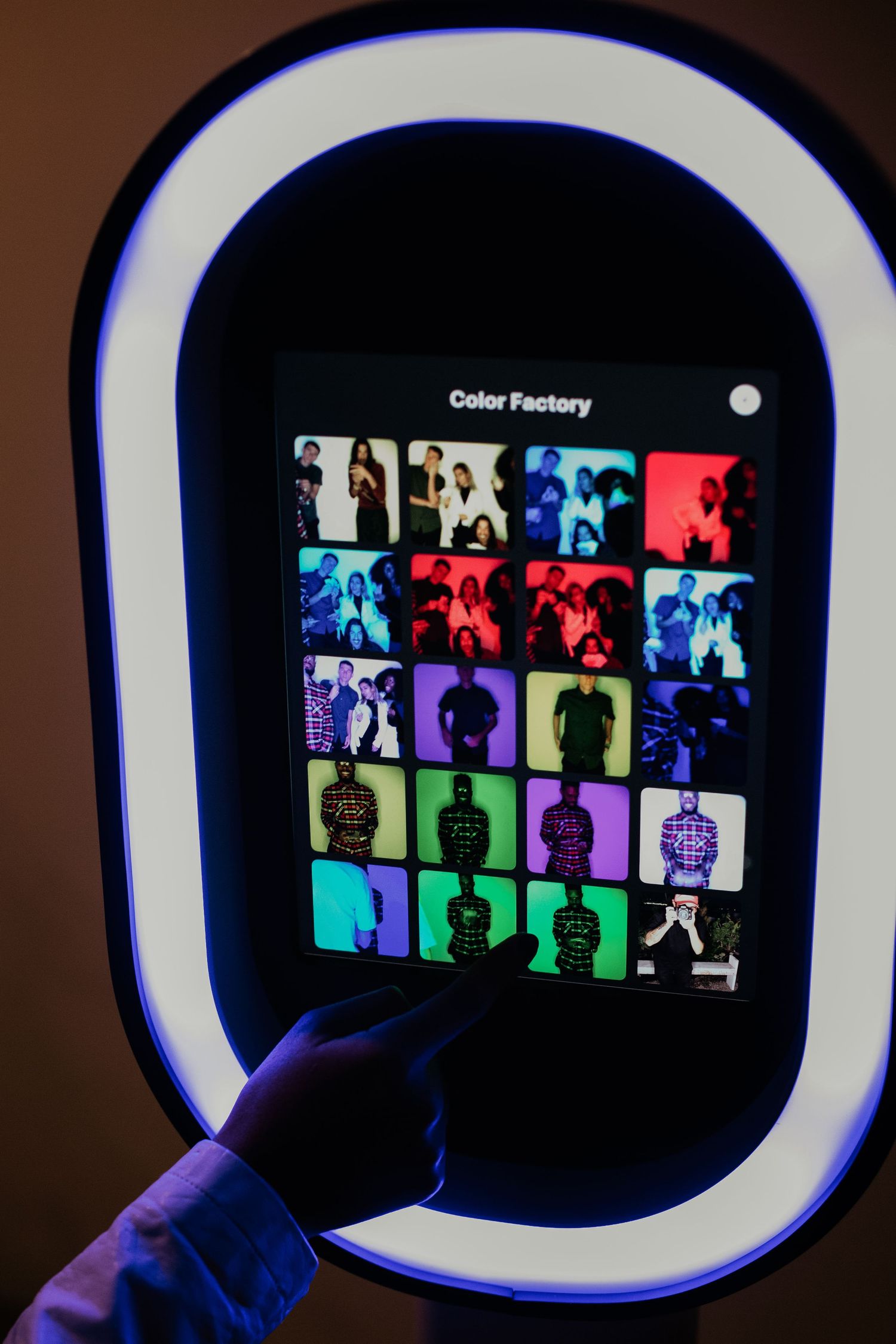 A colorful grid of silhouettes displayed on a dark screen with a glowing white border interface.