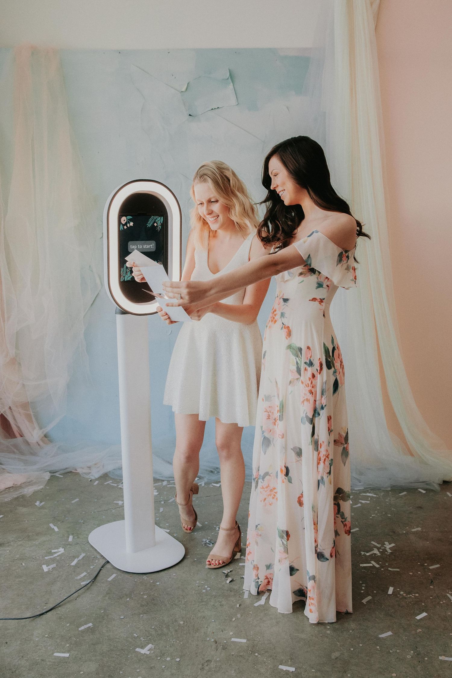 Several figures lean over to interact with a small white circular smart device in a series of four connected photos.