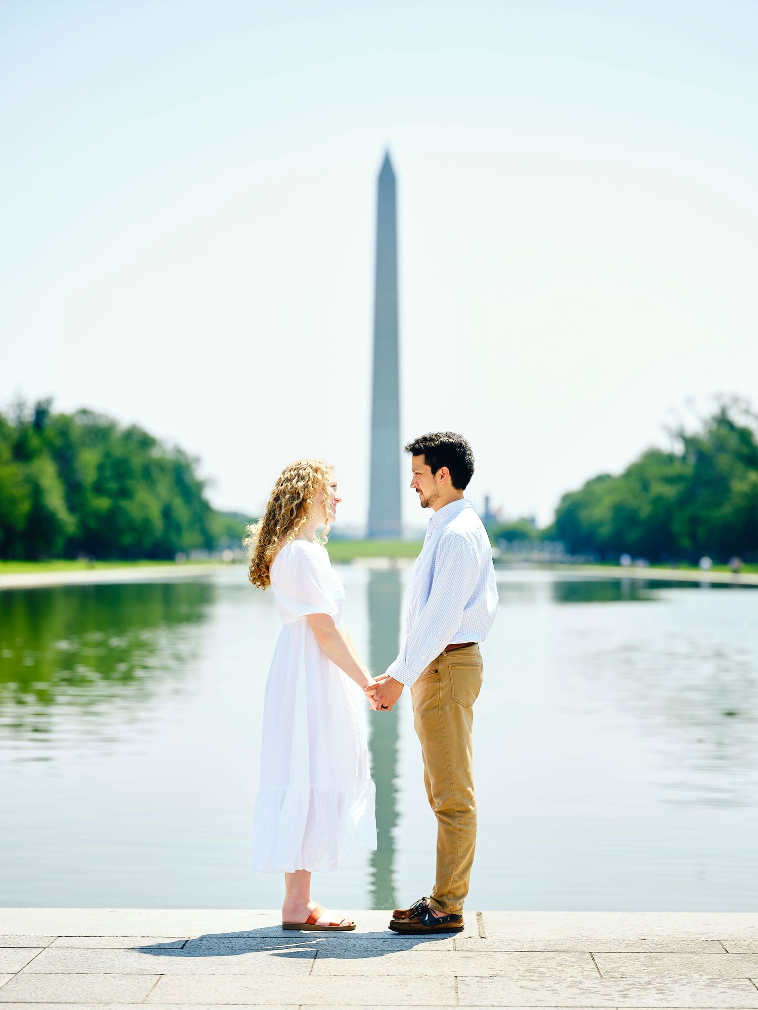 Iconic wedding portrait of couple holding hands in front of the Washington Monument.