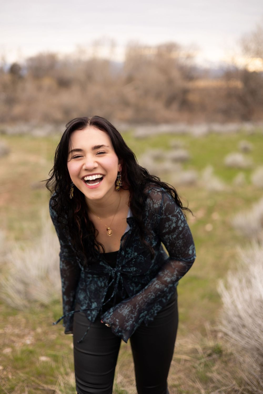 A series of candid outdoor portraits showing joyful expressions and laughter against a natural field backdrop.