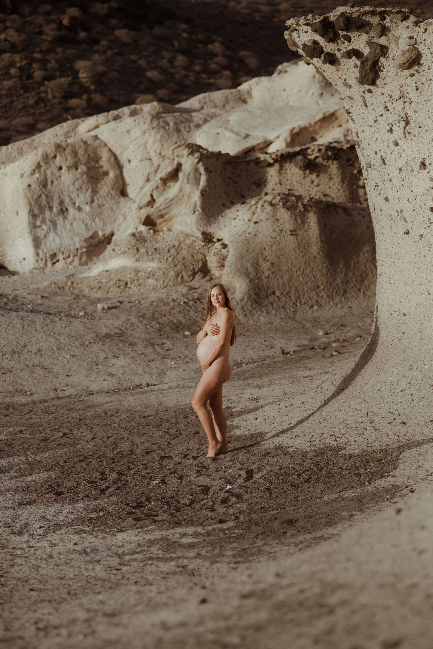A sequence of photos showing a cave or rock formation with sandy ground and textured walls.