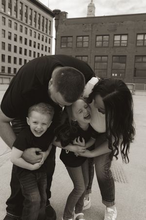 A candid moment of family joy and laughter captured in black and white.