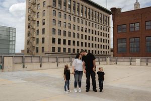 People enjoying a moment together on a downtown rooftop with tall buildings in view.
