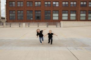 Urban rooftop scene with brick buildings and people walking together in the distance.