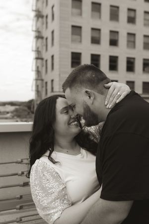 Black and white romantic sequence showing tender moments between a couple on a rooftop.