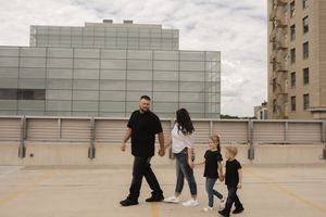 People interacting on an urban rooftop with modern buildings in background.