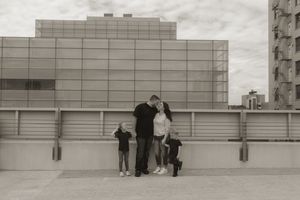 Panoramic view of figures on urban rooftop against industrial backdrop.