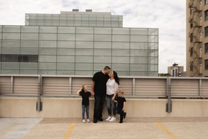 Black and white panoramic shot of people on urban rooftop.