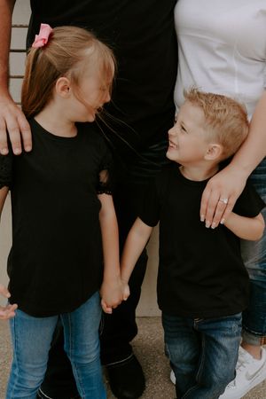 Close-up view of family members in casual attire showing affection.