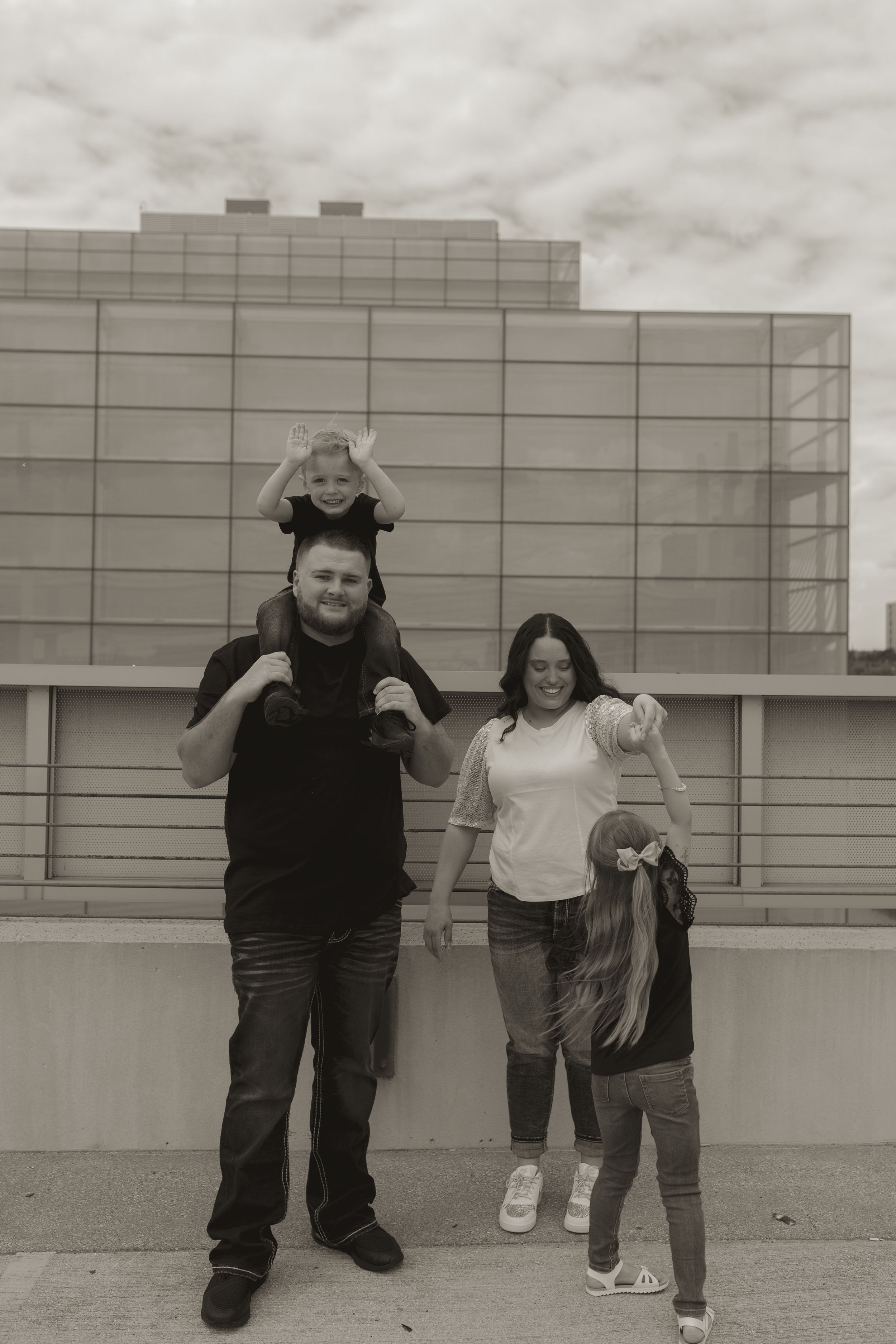 Black and white photo of family members sharing a fun moment together.