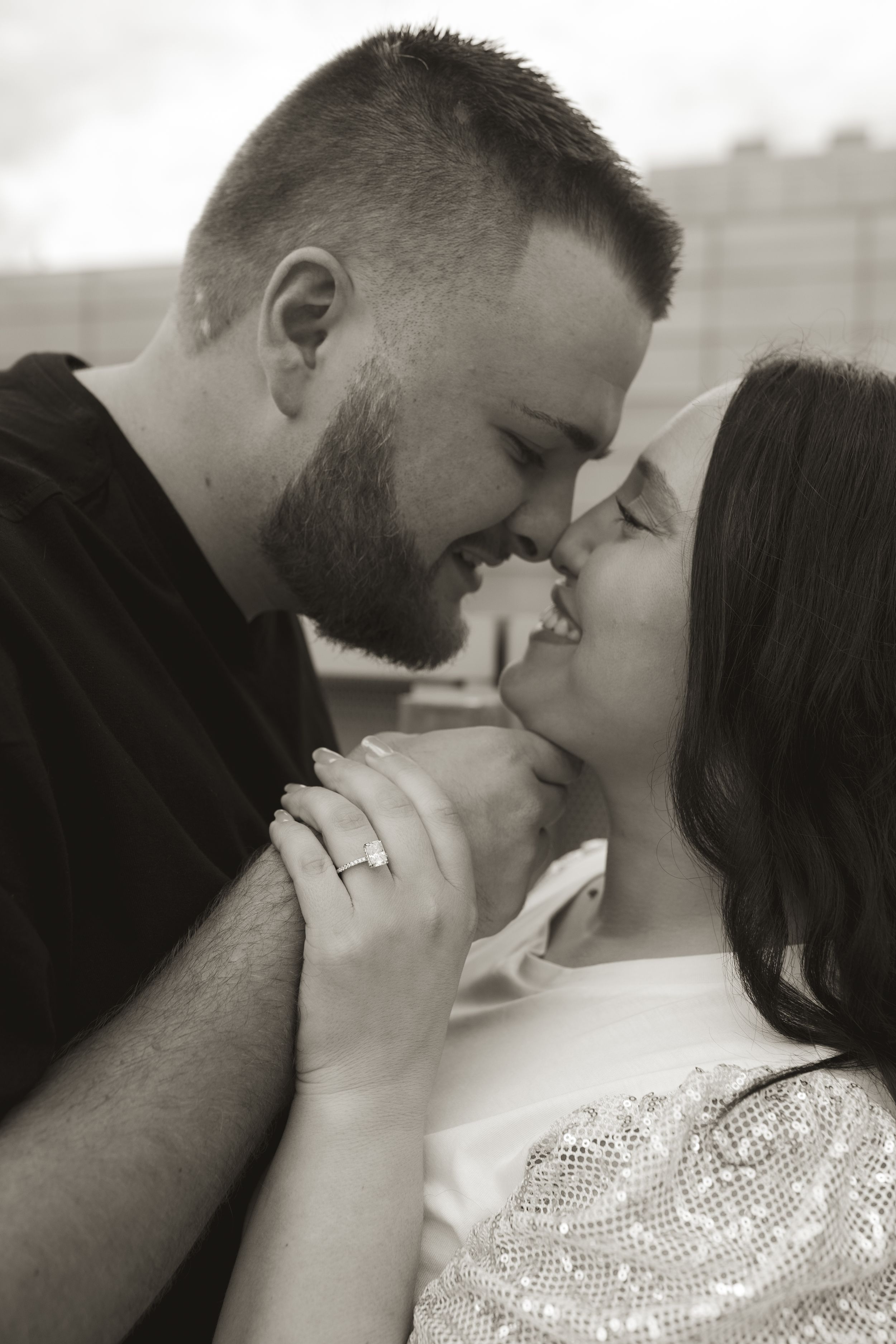 Close-up black and white portrait of a tender embrace between a couple.