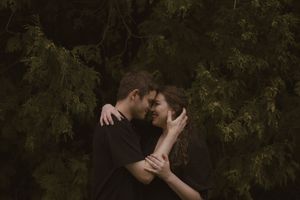 An intimate moment between two people captured in a natural outdoor setting.