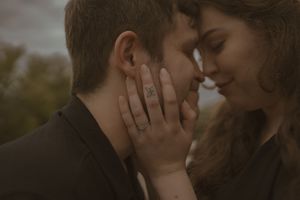 A close-up romantic moment between two people with soft natural lighting.