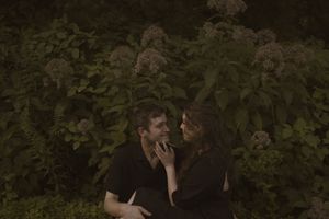 A romantic couple's portrait taken in a natural garden setting.