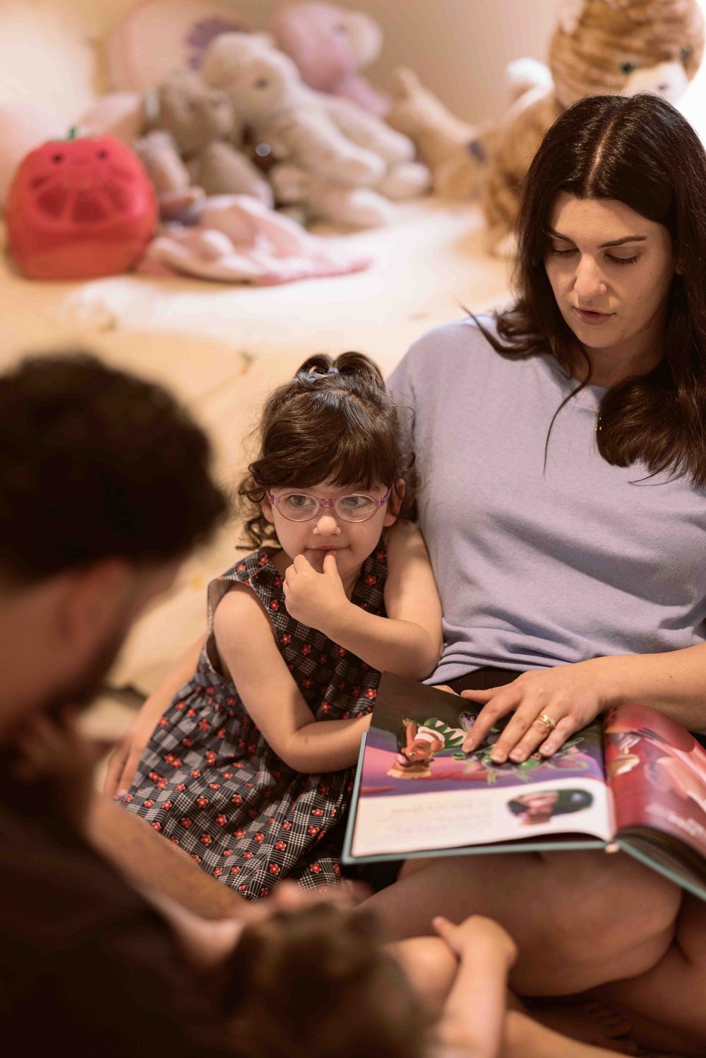 family reading books in the kids room