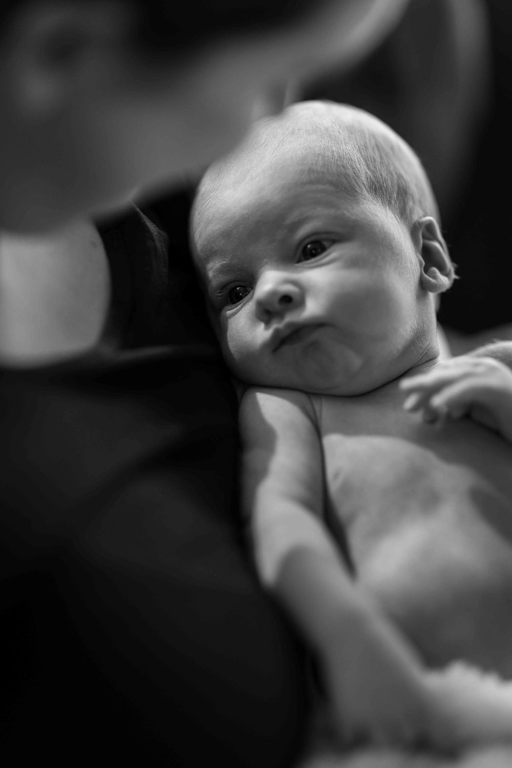 Black and white photo of Mum and newborn baby.Leigh Ball, Documentary family photographer