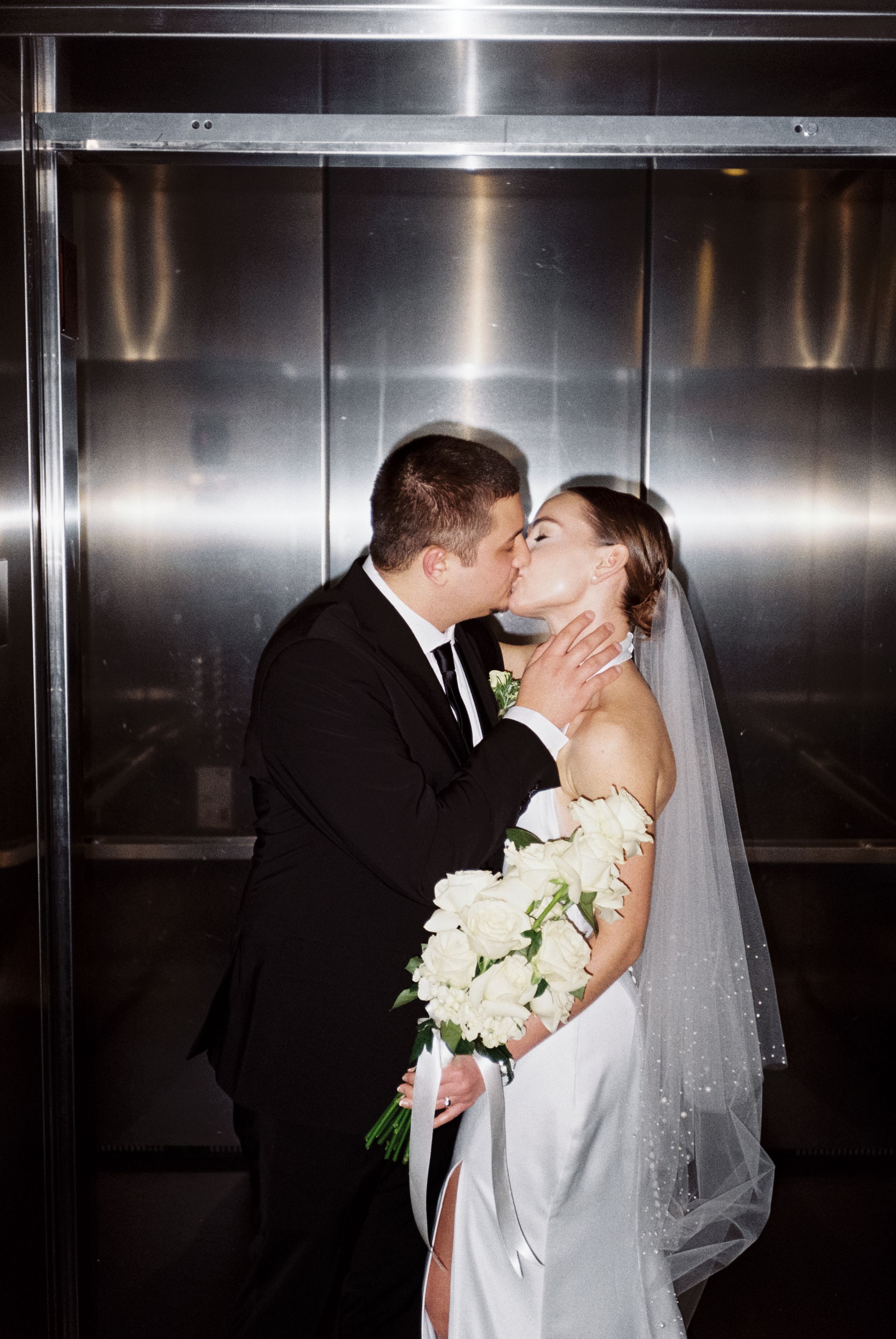 A romantic series of wedding photos showing a couple kissing in an elevator with a white bridal bouquet.