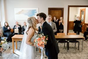 Collage of special moments from an intimate wedding ceremony showing loving embraces and romantic gestures in an indoor venue.