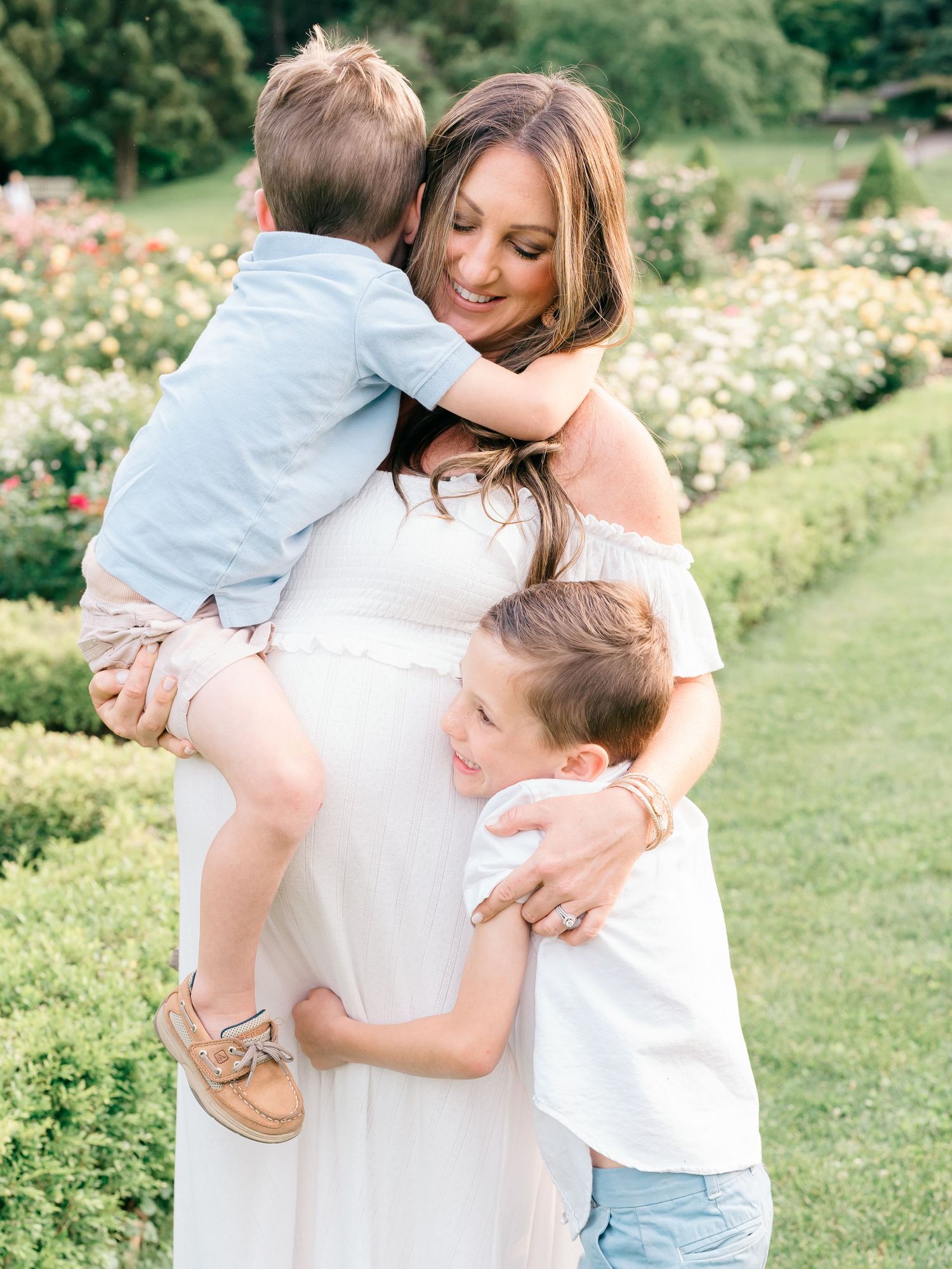 Mother and children snuggle together at a garden in Monmouth county nj.
