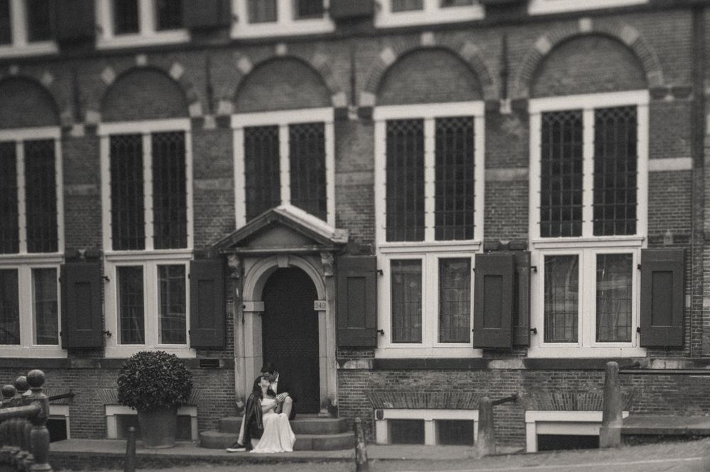 Historic brick building facade with arched windows and classic European architectural details.