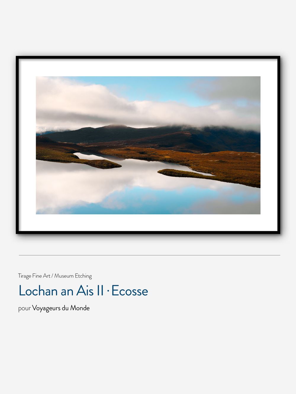 Panoramic landscape of Lochan an Ais lake in Scotland with misty mountains and reflective waters in moody lighting.