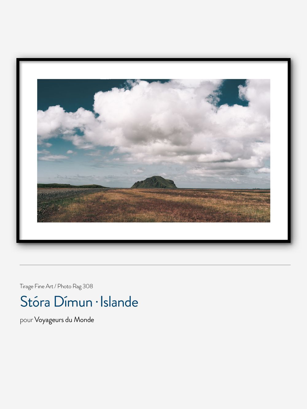Fine art print of Stóra Dímun island in Iceland, featuring dramatic clouds over rugged landscape, framed in black.