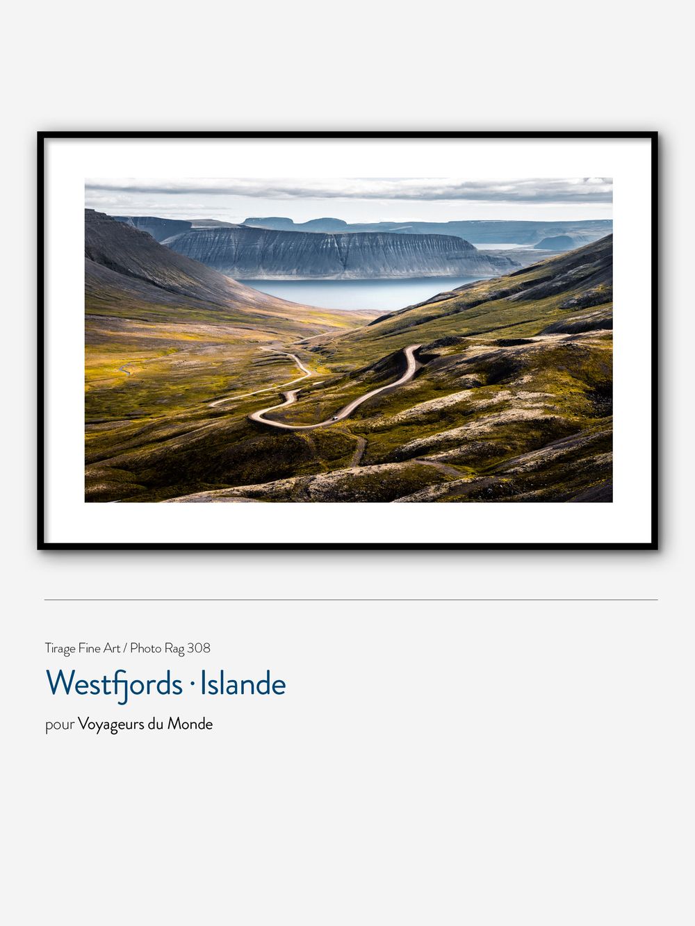 Framed fine art print of Iceland's Westfjords showing a winding mountain road leading to a serene fjord valley.