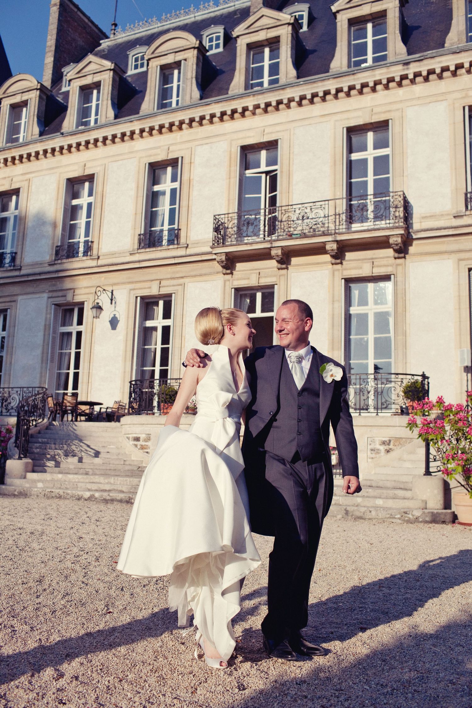 Elegant bride and groom portrait during a destination wedding in paris in front of chateau de santeny