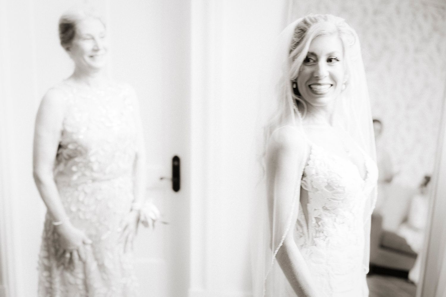 A series of black and white bridal portraits showing a lace wedding dress in different elegant poses.