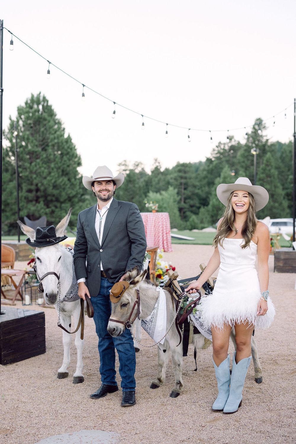 Group photo session with a miniature donkey on a rustic outdoor setting.