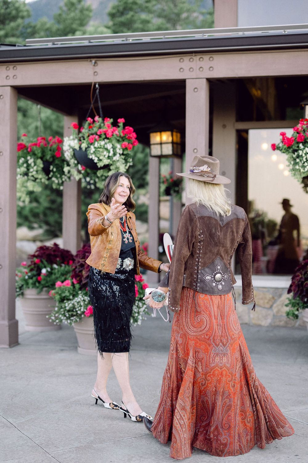 A series of photos showing a flowing rust-colored dress with paisley patterns against a rustic porch backdrop with red flowers.