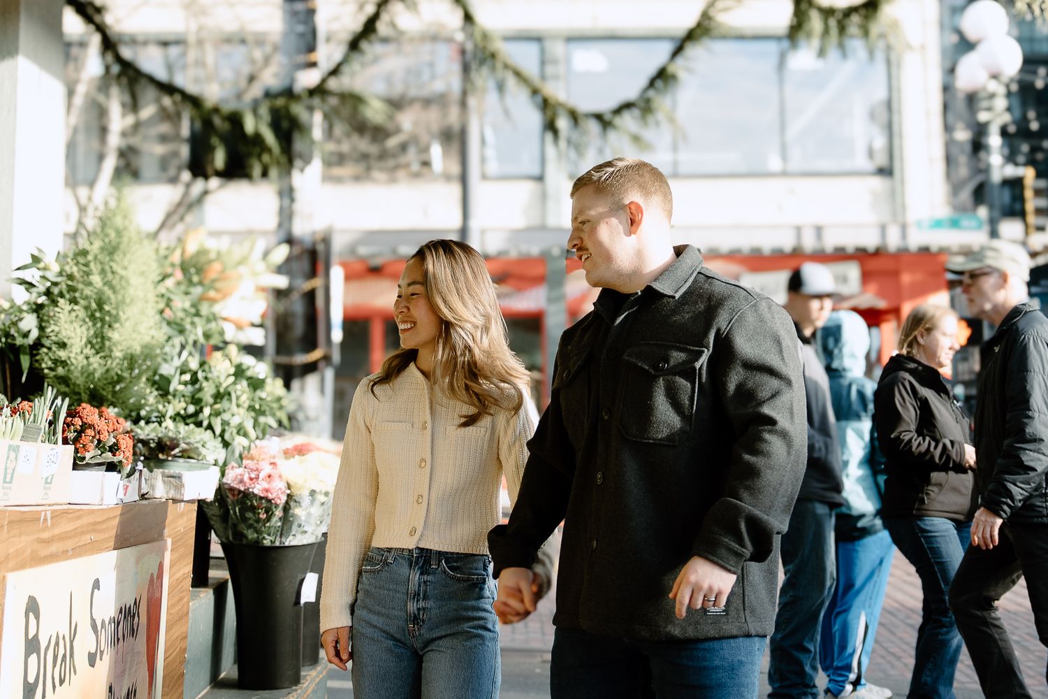 People enjoying drinks and conversation at a stylish outdoor cafe or bar setting in natural lighting.