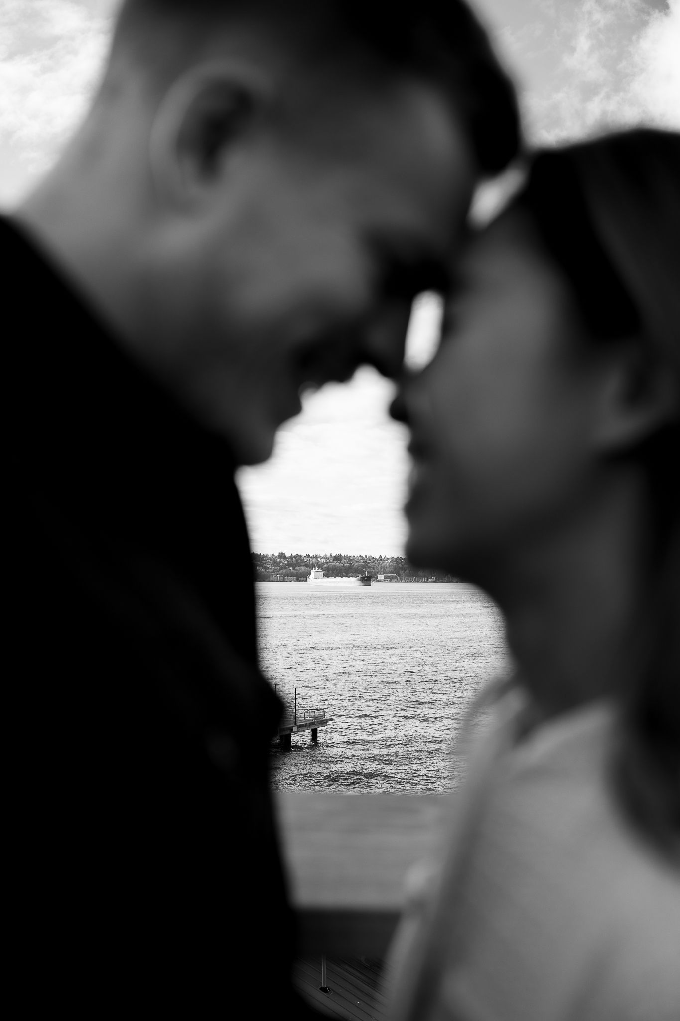 A series of silhouetted figures against an ocean horizon, gradually moving closer together in each frame.