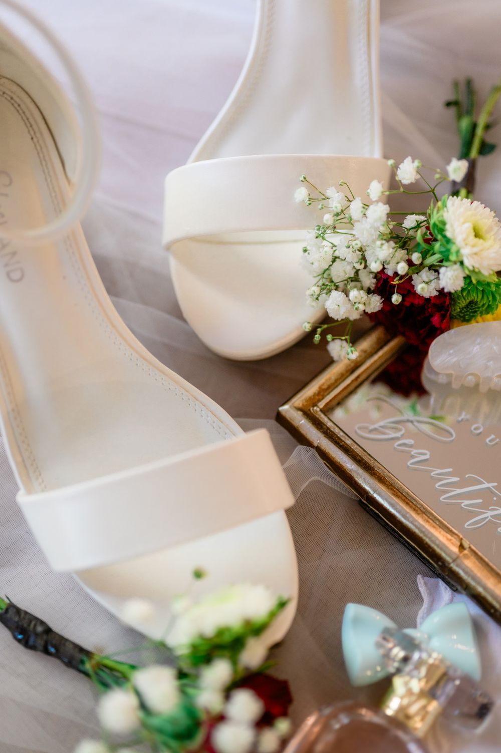 Wedding decor details featuring white ceramic pieces and delicate floral arrangements.