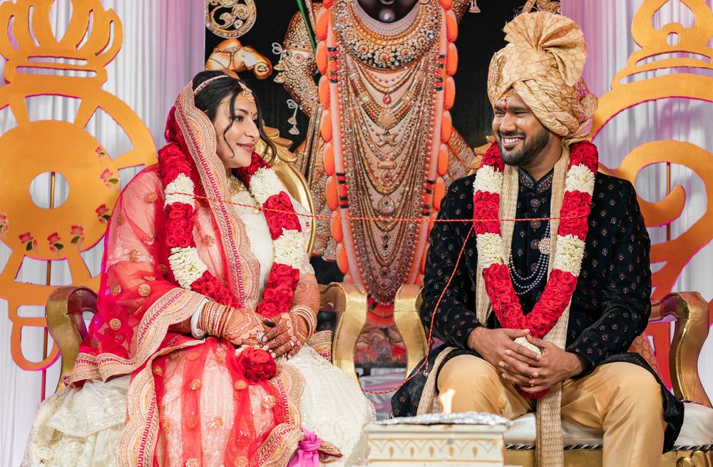 Traditional Indian wedding ceremony with guests seated in colorful attire during a festive celebration.