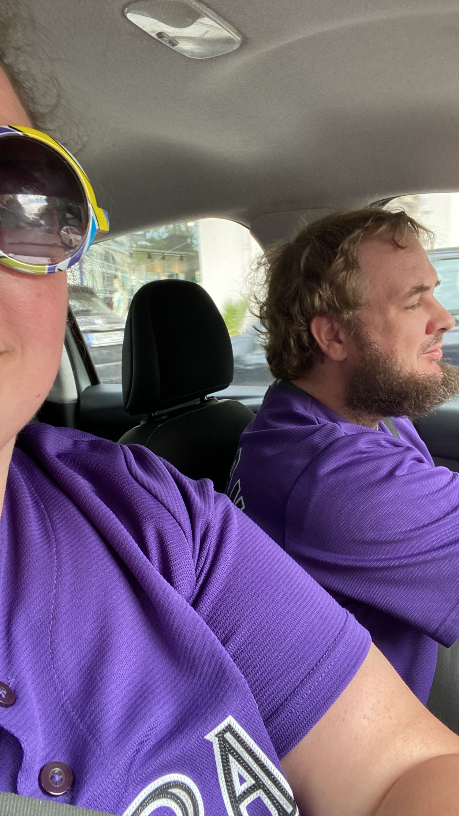 Person in purple hoodie shown in multiple angles while sitting in car interior.