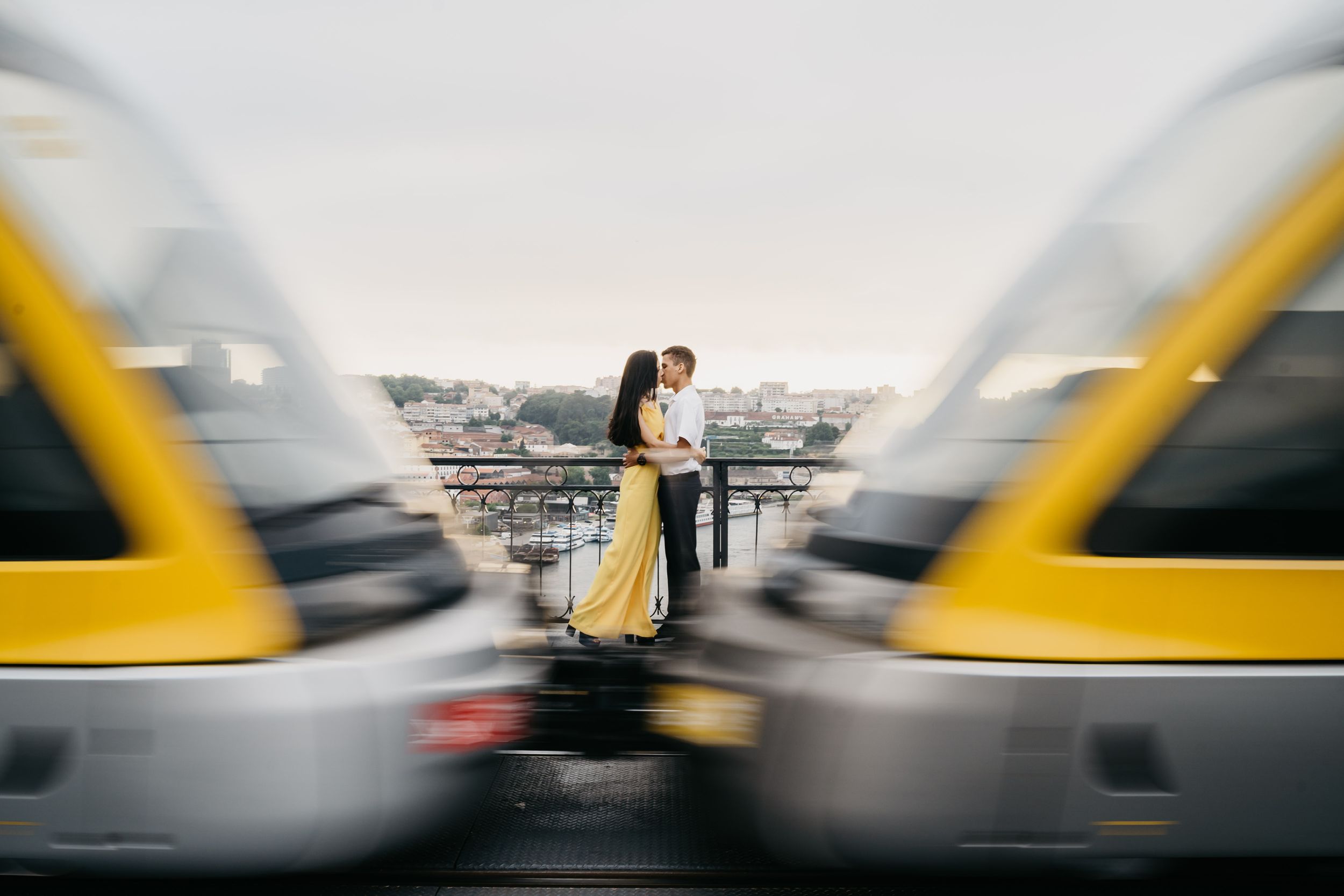 A series of blurred yellow taxi cabs create a dynamic motion effect against an urban backdrop.