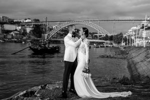 Black and white wedding photography series showing a couple by the water with dramatic skies.