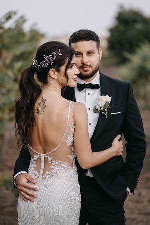Close-up details of a bride's lace wedding dress and jewelry accessories.