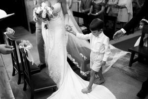 A bride in a flowing white gown twirls on the dance floor during a wedding reception celebration.