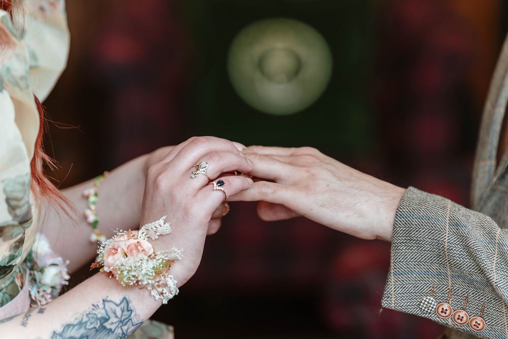 Wedding ceremony inside Thornbury Castle hall close up of ring exchange elopement