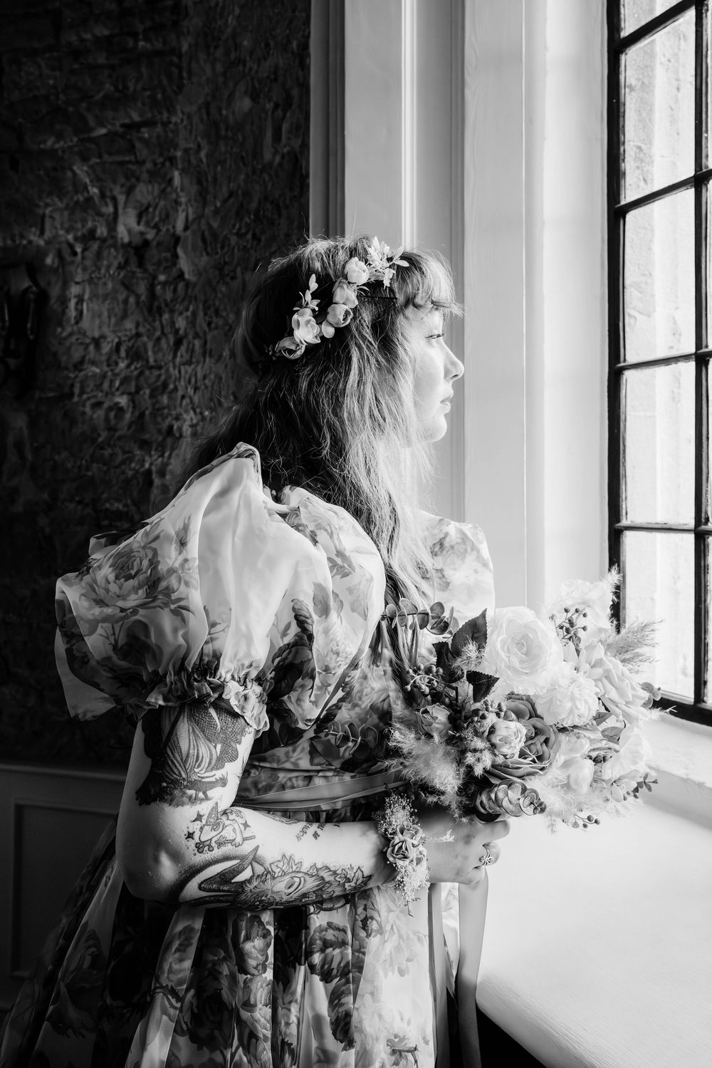 Bride and groom portraits at Thornbury Castle gloucestershire bride looking out of window