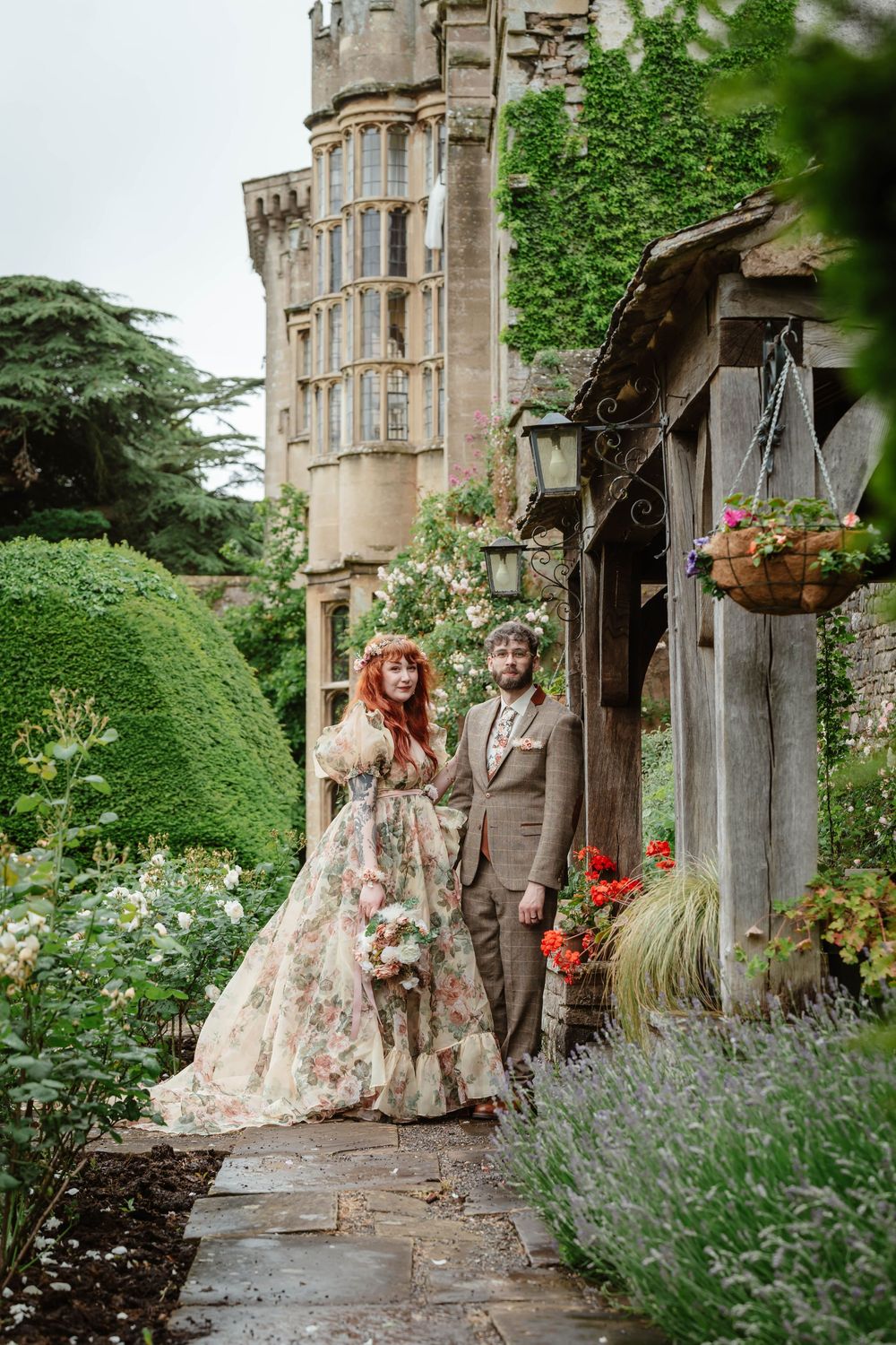 Bride and groom portraits at Thornbury Castle gloucestershire couple amongst the roses